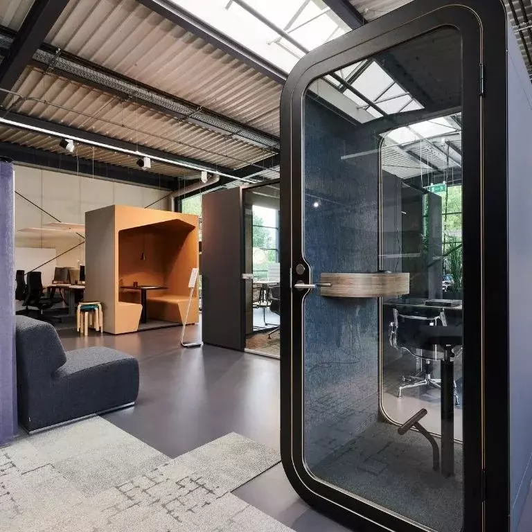 Modernes Kombibüro mit Zellen für Einzelarbeit, Büroarbeitsplätzen und Sitzlounge.